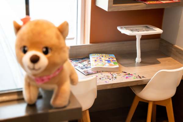 The children's play area at Rossland Landing Dental Care clinic in Ajax, ON. The image shows children's book, stuffed animals and toys.